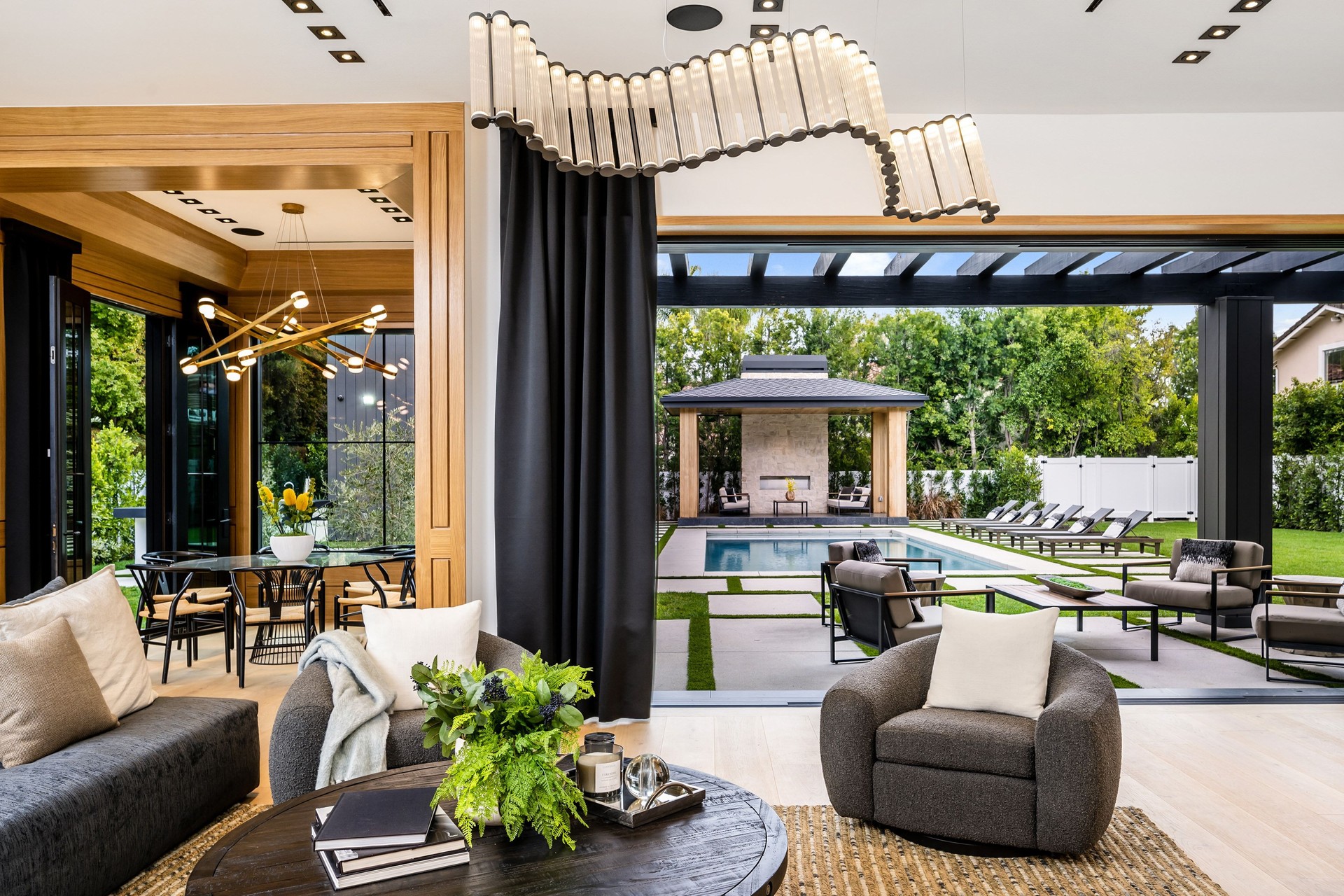 Modern living room with pool view and stylish decor.